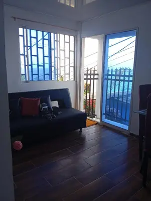a living room with a couch and large windows at Casa vista al mar in Puerto Colombia