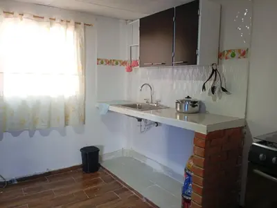 a small kitchen with a sink and a window at Casa vista al mar in Puerto Colombia