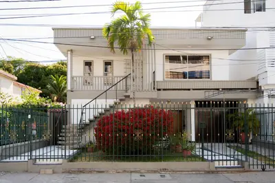 a white house with a wrought iron fence at Charming and relaxing in Manga! Close to Getsemaní in Cartagena de Indias