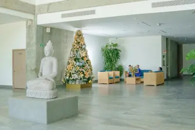 a christmas tree next to a statue in a building at I bedroom infinitum view 32nd floor in Cartagena de Indias