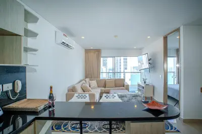 a kitchen and living room with a couch and a table at I bedroom infinitum view 32nd floor in Cartagena de Indias