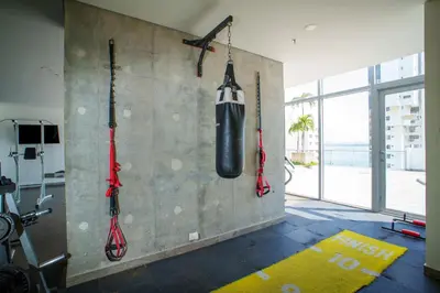 a gym with a punching bag hanging on a wall at I bedroom infinitum view 32nd floor in Cartagena de Indias