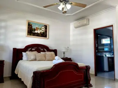 a bedroom with a bed with a ceiling fan at Beautiful Furnished House in CTG in Cartagena de Indias