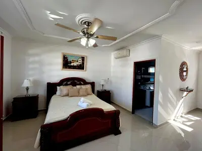 a bedroom with a bed and a ceiling fan at Beautiful Furnished House in CTG in Cartagena de Indias