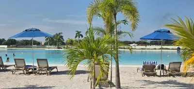 a group of chairs and umbrellas on a beach at Baia Kristal Cartagena Kabo 2-3N in Los Arrayanes