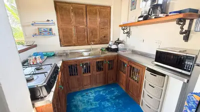 a kitchen with a sink and a stove at Cabaña Punta Helvetica in San Antero