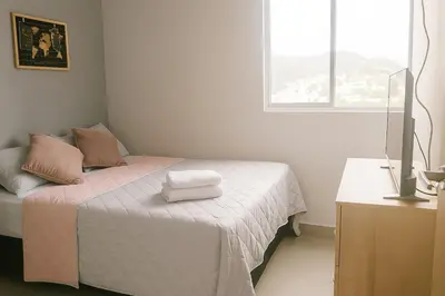 a bedroom with a bed with two towels on it at Oasis Costero Apartment in Cartagena de Indias