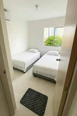 a room with two beds and a window at VIP Cartagena Close to the 415 Wall in Cartagena de Indias