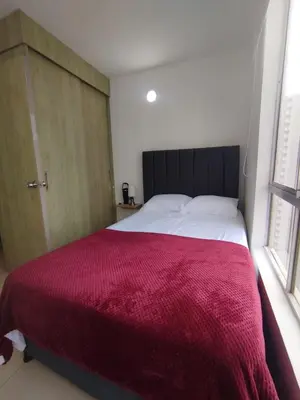 a bedroom with a large bed with a red blanket at Cartagena near the historic center and beaches in Cartagena de Indias