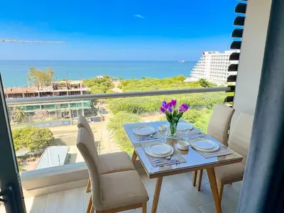 a dining table with a view of the ocean at Lujoso apartamento para estrenar Terraz - Playa Dormida in Santa Marta