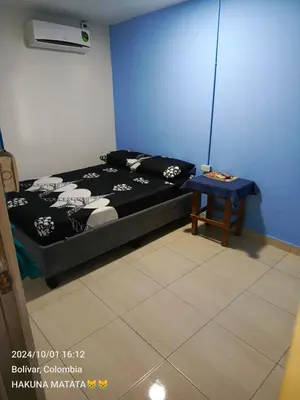 a bedroom with a bed and a table in it at Hospedaje Bosque Mar in Cartagena de Indias
