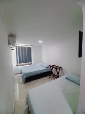 a room with two beds and a window in it at HOTEL DIMAR i in Cartagena de Indias