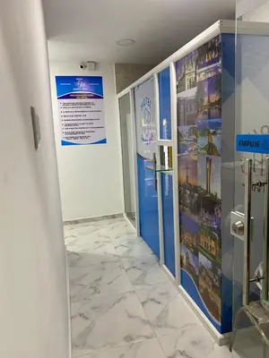 a room with a walk in shower and a refrigerator at Hotel Santa Ana in Baranoa