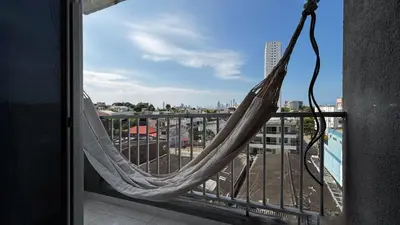 a hammock on a balcony with a view of a city at Modern Apartment Near the Sea in Cartagena de Indias