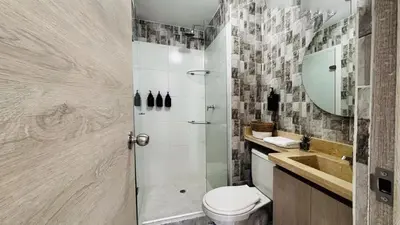 a bathroom with a shower and a toilet and a sink at Modern Apartment Near the Sea in Cartagena de Indias