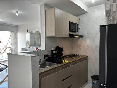 a kitchen with a sink and a refrigerator at Modern Apartment Near the Sea in Cartagena de Indias