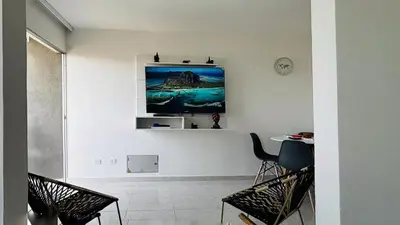 a living room with a tv on a wall at Modern Apartment Near the Sea in Cartagena de Indias