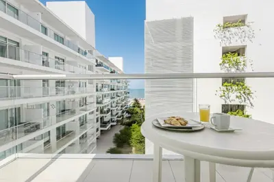 a white table with a plate of food on a balcony at Morros Flamingo Suite - con vista al mar y acceso a la playa in Cartagena de Indias