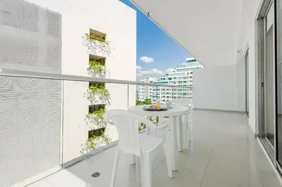 a balcony with a white table and chairs at Morros Flamingo Suite - con vista al mar y acceso a la playa in Cartagena de Indias