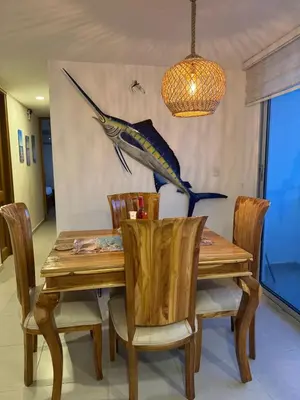 a dining room table with a fish on the wall at Palo Rosa Caribe 202 in Coveñas