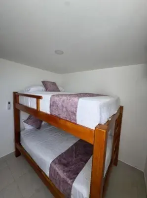 two wooden bunk beds in a room with at Palo Rosa Caribe 202 in Coveñas