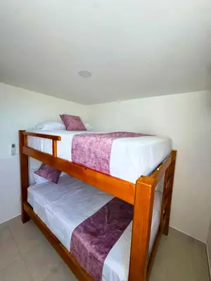two bunk beds in a small room with at Palo Rosa Caribe 202 in Coveñas
