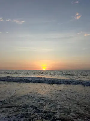 a sunset on the beach with the ocean at shanty guest hostal in Cartagena de Indias