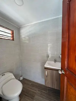 a bathroom with a toilet and a sink at Cabaña la fortuna in Turbaco