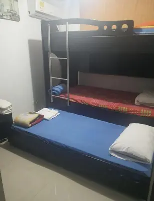 a bunk bed in a dorm room with a blue bed at APARTAMENTO-Miramar in Barranquilla