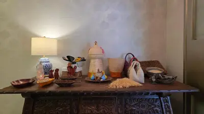 a table with a lamp and baskets on it at Hotel Casa La Tablada Aeropuerto in Cartagena de Indias