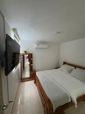 a bedroom with a bed and a flat screen tv at Conjunto Residencial Caribe Campestre in Coveñas