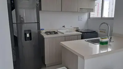 a kitchen with a refrigerator and a counter top at Dúplex en Bocagrande Cartagena Piscina, jacuzzi y a 2 cuadras del mar in Cartagena de Indias