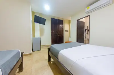 a hotel room with two beds and a window at Hotel El Viajero #2 in Cartagena de Indias