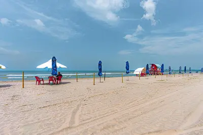 a beach with chairs and umbrellas and the ocean at Bohemian 2BR - Morros Kai - Private pool & parking in Cartagena de Indias