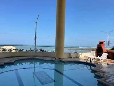 a swimming pool with a view of the ocean at Altamar suite Cabrero in Cartagena de Indias