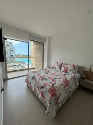 a bedroom with a bed with a view of the ocean at Baia Kristal Cartagena in Cartagena de Indias