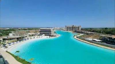 a large pool of blue water next to a beach at Baia Kristal Cartagena in Cartagena de Indias