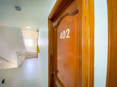 a door with the number on it in a hallway at Hotel Aeromar Central in Santa Marta
