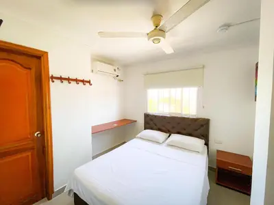 a bedroom with a bed and a ceiling fan at Hotel Aeromar Central in Santa Marta