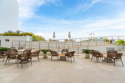 a patio with tables and chairs on a roof at Magica Cartagena Suite in Cartagena de Indias