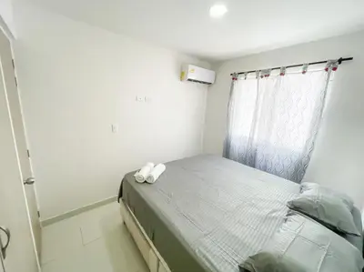 a small bedroom with a bed with a curtain at Apartamento 3 hab a paso del mar in Cartagena de Indias