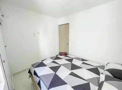 a bedroom with a black and white checkered floor at Apartamento 3 hab a paso del mar in Cartagena de Indias