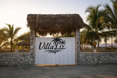 a white gate with a palm tree on it at Villa Liz in Puebloviejo
