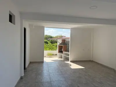 an empty room with a view of a house at Private pool cabin near the sea Puerto Velero in Tubará