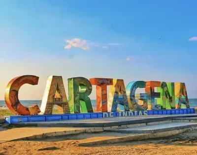 a sign on the beach with the ocean in the background at Alina Beautiful Cartagena Apartment in Cartagena de Indias