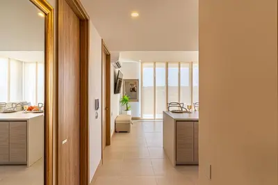 a hallway of a home with a kitchen with counters at Exclusive 2BR en Morros Eos with Pool & Parking in Cartagena de Indias