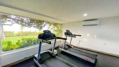 a gym with two tread machines and a window at Comodos Aptos en Morros3 con salida directa a la playa, piscina & parking in Cartagena de Indias