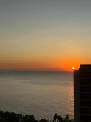a sunset over the ocean from a building at All new apartment in Santa Marta - NR Stays in Santa Marta