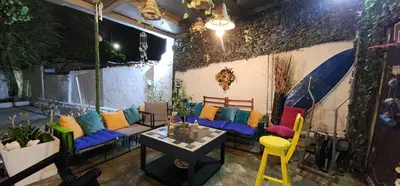 a patio with colorful couches and a table and chairs at Casa playa salgar in Puerto Colombia