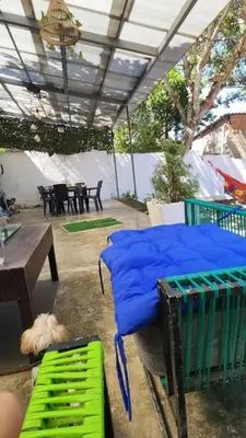 a bed with blue pillows on a patio at Casa playa salgar in Puerto Colombia